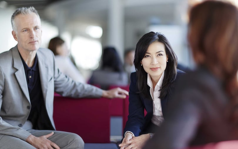 Business people talking in office lobby